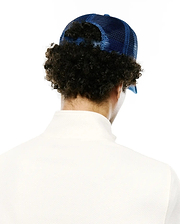 Mens Adamo Bunny Trucker Cap in vibrant royal blue with a breathable mesh back and adjustable snap closure, paired with a crisp white collared polo shirt featuring a classic pique texture.