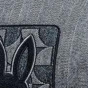 Grey herringbone jacket with black ribbed collar and large embroidered Psycho Bunny skull logo on back, paired with a black Jimmy Baseball Cap featuring a metal logo buckle.