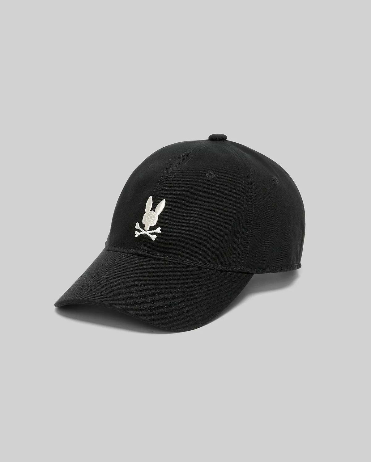 Black Jimmy Baseball Cap with a classic fit, featuring a prominent white embroidered Psycho Bunny skull logo on the front, made from durable cotton twill.
