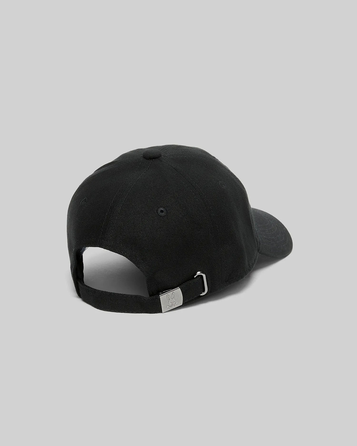 Jimmy Baseball Cap in black cotton twill, featuring a classic fit and an adjustable strap with a silver metal buckle engraved with the iconic Psycho Bunny skull logo at the back.