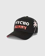 Black Mens Brad Trucker Cap featuring bold white PSYCHO and coral BUNNY text on the front, an embroidered white and coral palm tree graphic on the side, and a vibrant coral underside brim.