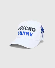 White Mens Brad Trucker Cap featuring large embroidered PSYCHO in dark blue and BUNNY in bright blue on the front, with an embroidered blue palm tree on the side.
