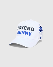 White Mens Brad Trucker Cap featuring large embroidered PSYCHO in dark blue and BUNNY in bright blue on the front, with an embroidered blue palm tree on the side.