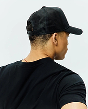Black classic fit jersey t-shirt with a crew neck, paired with a black Mens Tobias Trucker Cap featuring a breathable mesh back and adjustable snap closure.