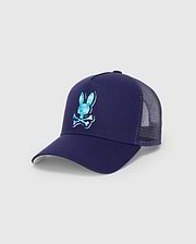 Mens Ethan Trucker Cap in navy blue, featuring a large, embroidered Psycho Bunny skull logo with a blue and teal patterned fill on the front, mesh back, and a light green underbrim.