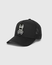 Black Mens Elijah Trucker Cap featuring a prominent white embroidered Psycho Bunny skull logo on the front, with a structured twill front and breathable mesh back panels.