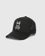 Black Mens Elijah Trucker Cap featuring a prominent white embroidered Psycho Bunny skull logo on the front, with a structured twill front and breathable mesh back panels.