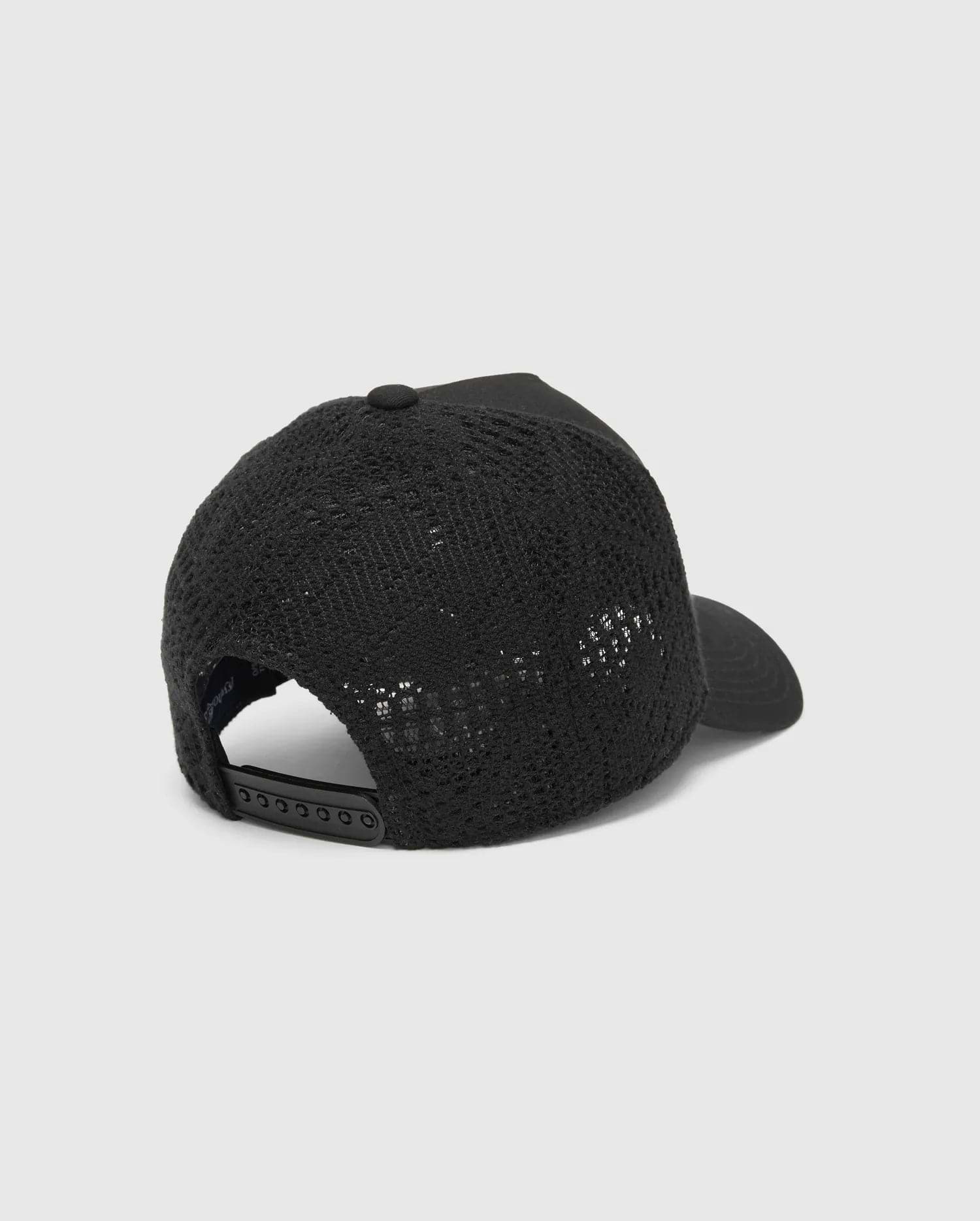 Black Mens Elijah Trucker Cap with breathable mesh back, solid front panel, and adjustable snapback closure, featuring subtle Psycho Bunny branding.