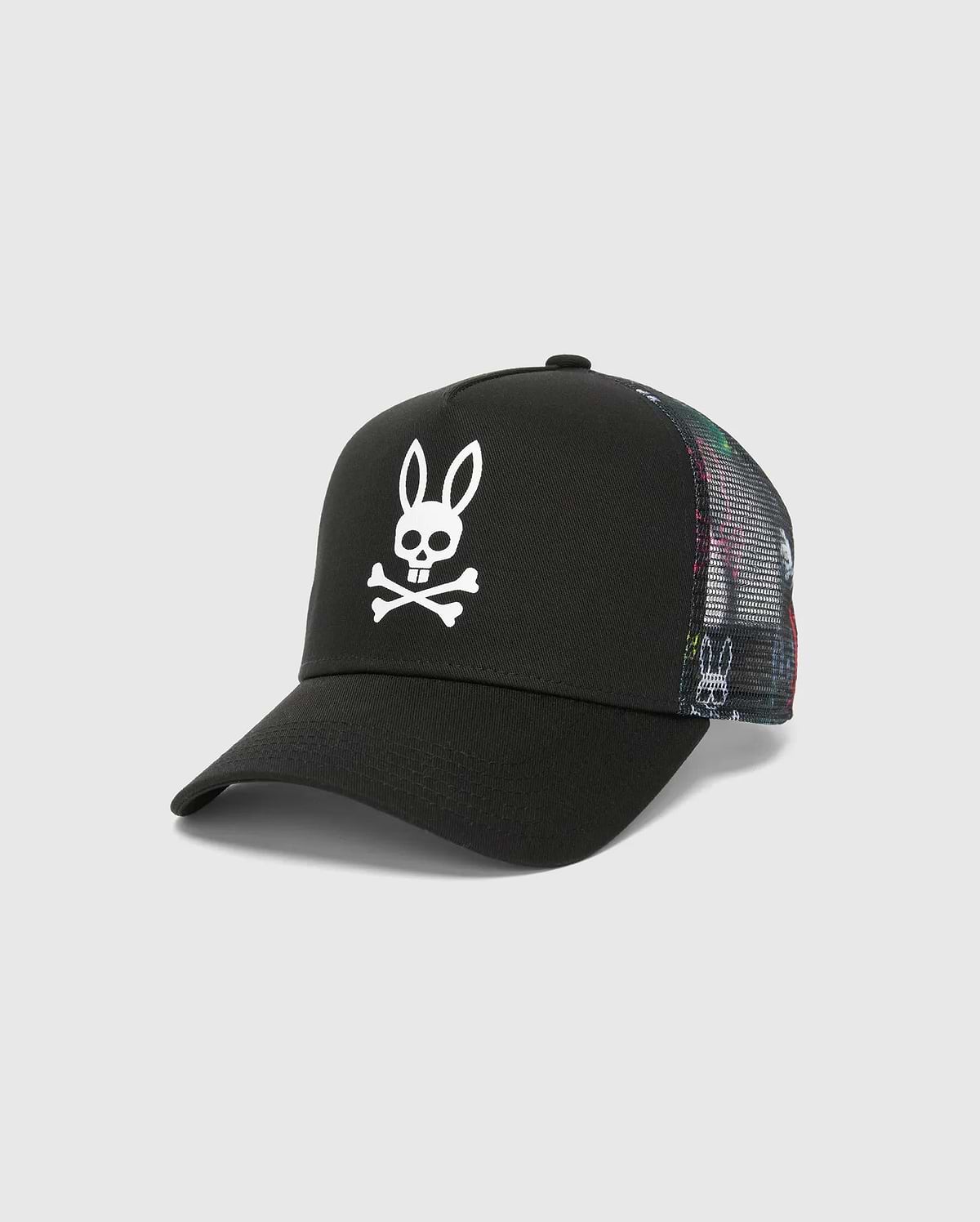 Mens Quintin Trucker Cap featuring a black twill front panel, multicolor patterned mesh back, and a prominent white embroidered Psycho Bunny skull logo.