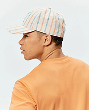 Mens Antoine Seersucker Baseball Cap in cream with orange and blue vertical stripes, paired with an orange pique knit crew neck t-shirt.