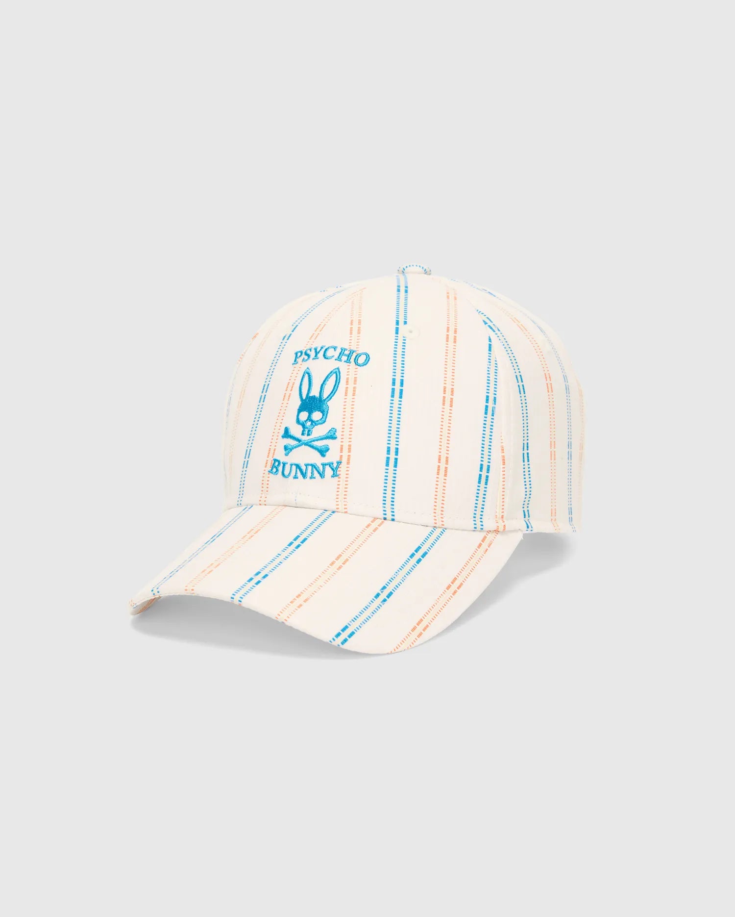 Mens Antoine Seersucker Baseball Cap, cream with blue and orange vertical stripes, featuring a prominent embroidered blue Psycho Bunny skull logo on the front.