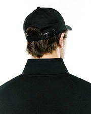 Black Mens Ambrose Baseball Cap featuring an adjustable strap with a silver metal buckle engraved with the iconic Psycho Bunny skull logo, paired with a black classic fit pique polo shirt with a ribbed collar.