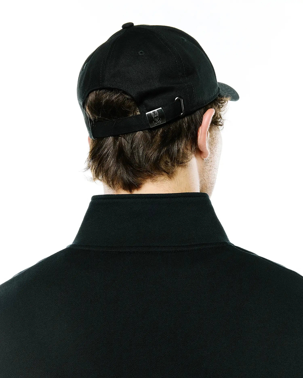Black Mens Ambrose Baseball Cap featuring an adjustable strap with a silver metal buckle engraved with the iconic Psycho Bunny skull logo, paired with a black classic fit pique polo shirt with a ribbed collar.