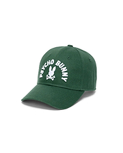 Mens Ambrose Baseball Cap in dark green cotton twill, featuring a large white embroidered Psycho Bunny logo with arched text and bunny skull on the front.
