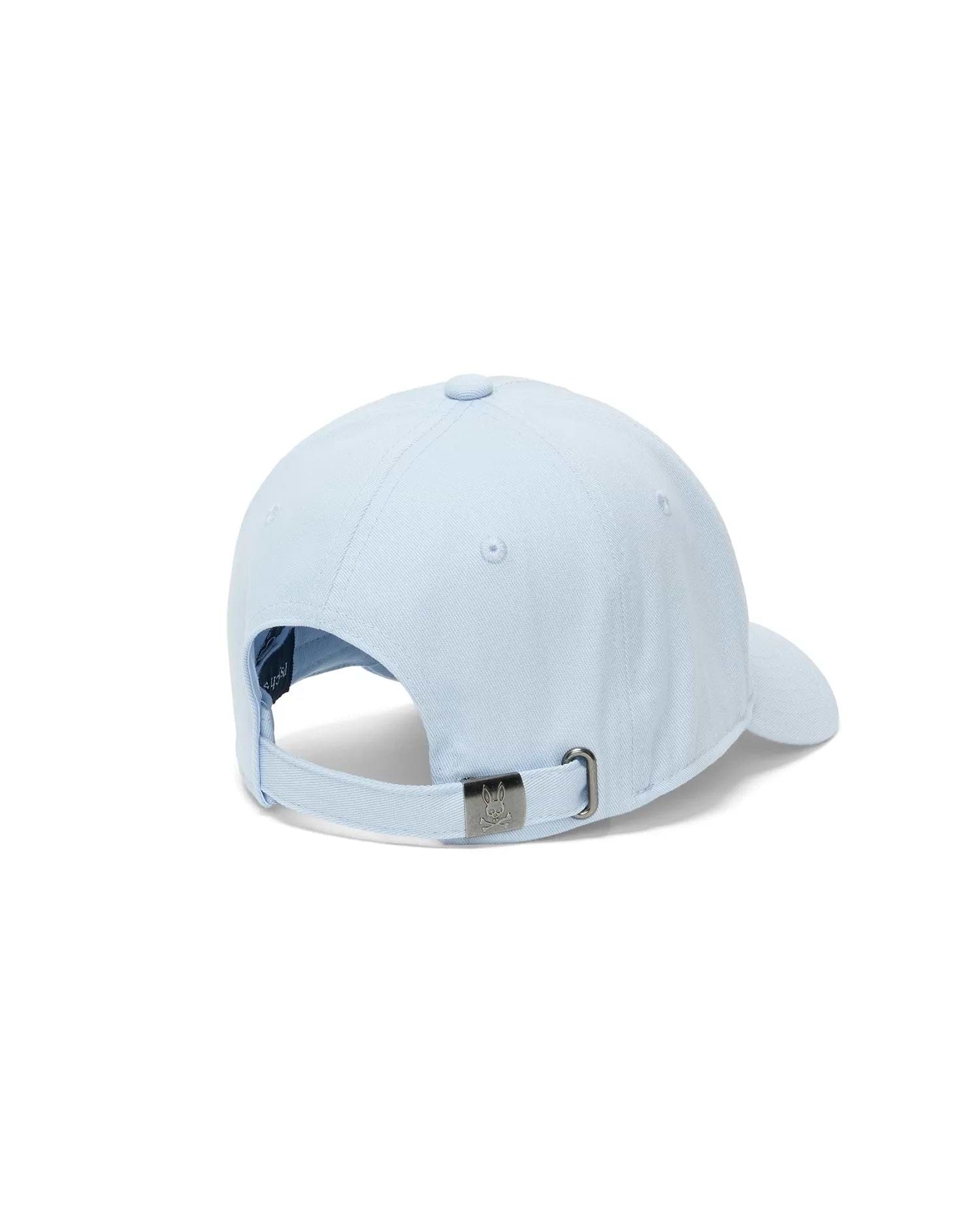 Mens Ambrose Baseball Cap, a classic fit in light blue cotton twill, featuring an adjustable strap with a gunmetal buckle engraved with the iconic Psycho Bunny skull logo.