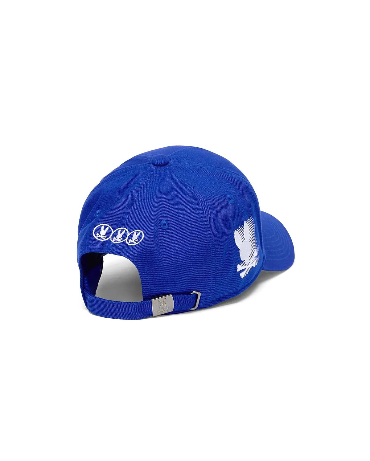 Mens Nathaniel A-Frame Trucker Cap, royal blue with a large distressed white Psycho Bunny skull logo on the right, three small white circular logos on the back, and a silver buckle with a logo.