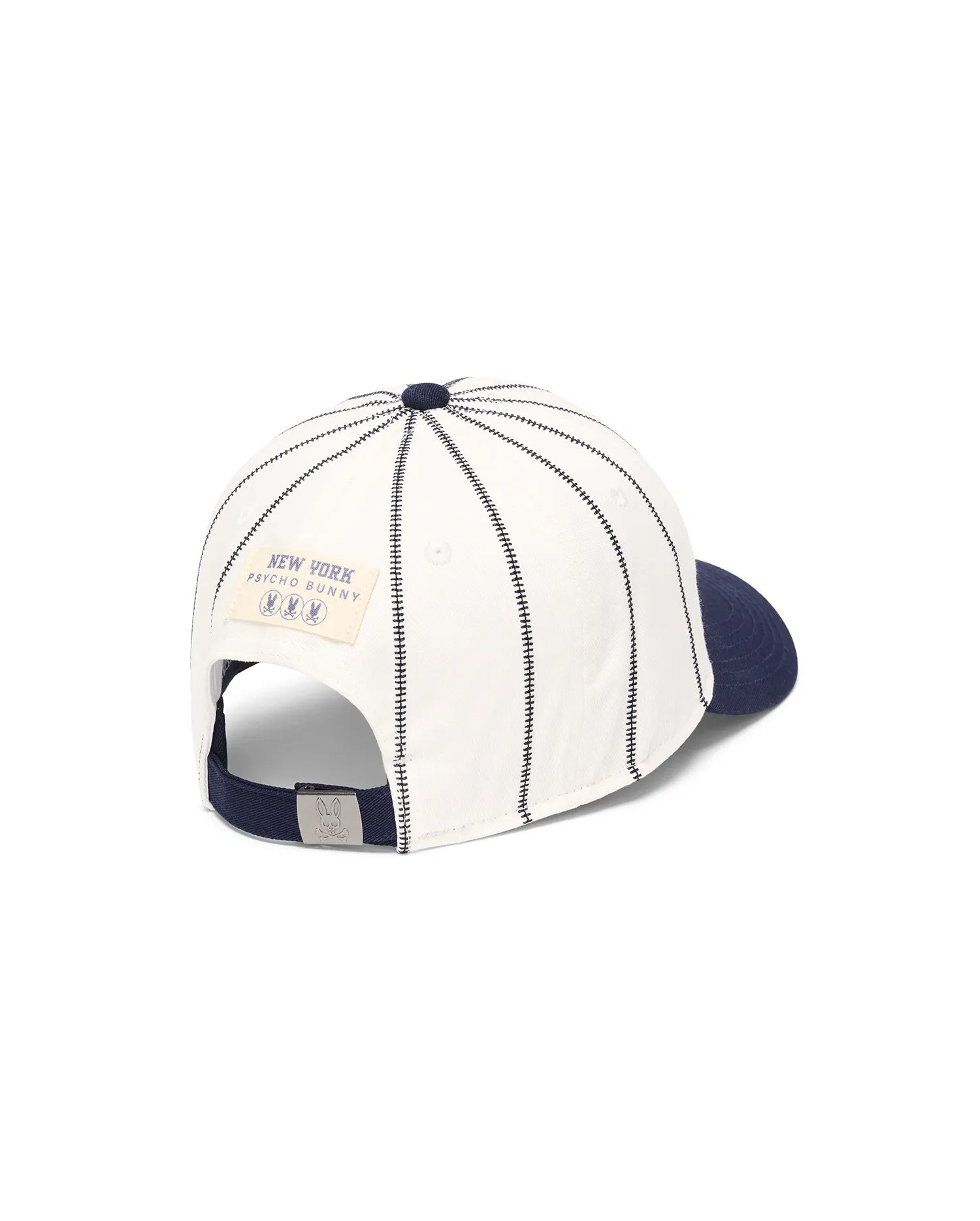 Mens Nathaniel Soft Baseball Cap, off-white cotton twill with navy brim, black stitched pinstripes, rear New York Psycho Bunny patch, and silver bunny skull buckle.