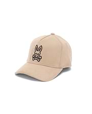 Mens Kenneth A-Frame Trucker Cap in beige, featuring a prominent black embroidered iconic Psycho Bunny skull logo on the front, with a smooth, suede-like texture.