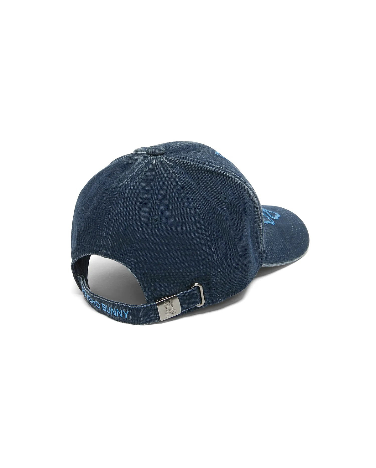 Men's Grover Baseball Cap in dark blue faded denim, featuring light blue embroidered Psycho Bunny text on the adjustable back strap and an engraved bunny skull on the metal buckle. (4)