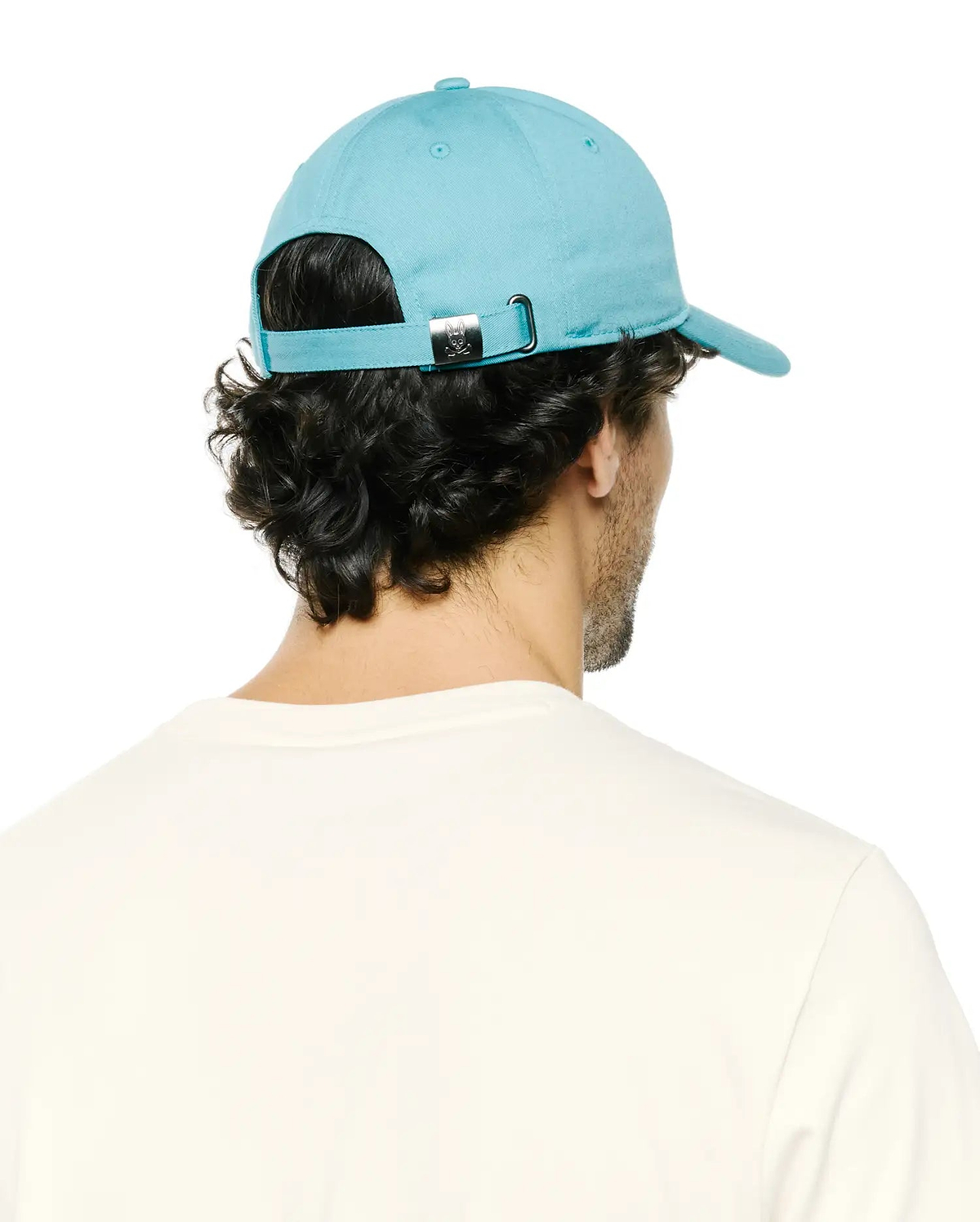 Men's Alfie Baseball Cap in vibrant aqua blue, featuring a smooth cotton twill texture, an adjustable back strap with a silver metal buckle, and a small engraved Psycho Bunny skull logo. (3)