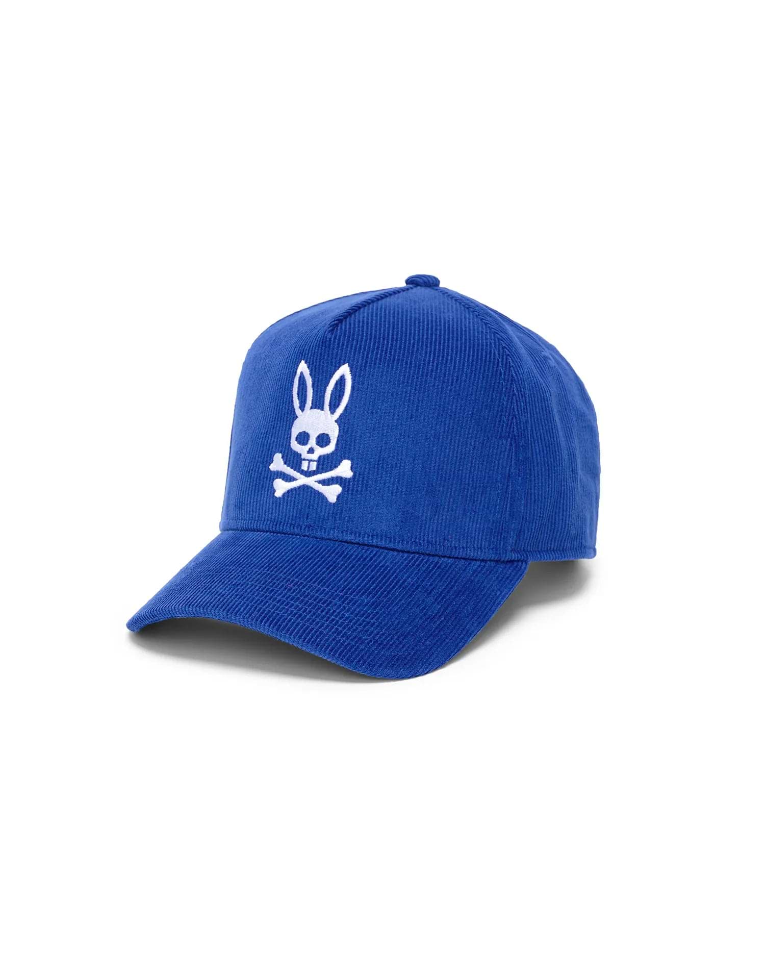 Mens Finnley Bunny Corduroy Trucker Cap in royal blue corduroy, featuring a prominent white embroidered Psycho Bunny skull and crossbones logo on the front.
