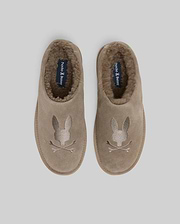 Mens Suede Sherpa Bunny Slipper in taupe, featuring a plush brown sherpa lining and a large embroidered Psycho Bunny skull logo on the toe, with brand text on the insole.