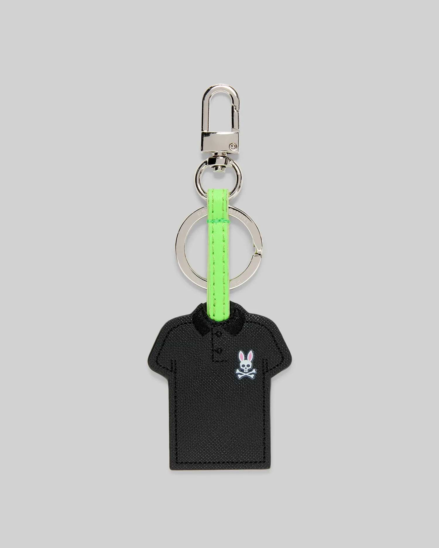Iconic Polo Keychain featuring a black textured faux leather polo shirt shape with a small embroidered pink and white Psycho Bunny skull logo, attached to a silver metal clasp and key ring with a vibrant neon green strap.