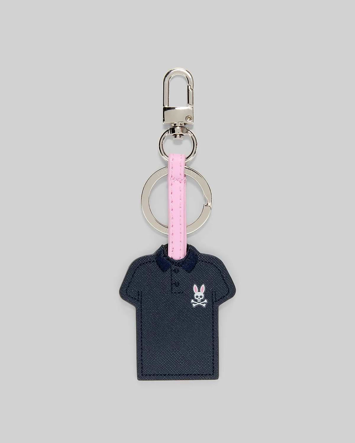 Iconic Polo Keychain featuring a navy blue textured faux leather polo shape with a small pink and white Psycho Bunny skull logo on the left chest, attached to a pink strap and silver metal hardware.