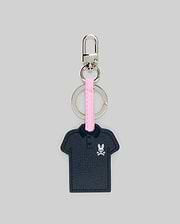 Iconic Polo Keychain featuring a navy blue textured faux leather polo shape with a small pink and white Psycho Bunny skull logo on the left chest, attached to a pink strap and silver metal hardware.