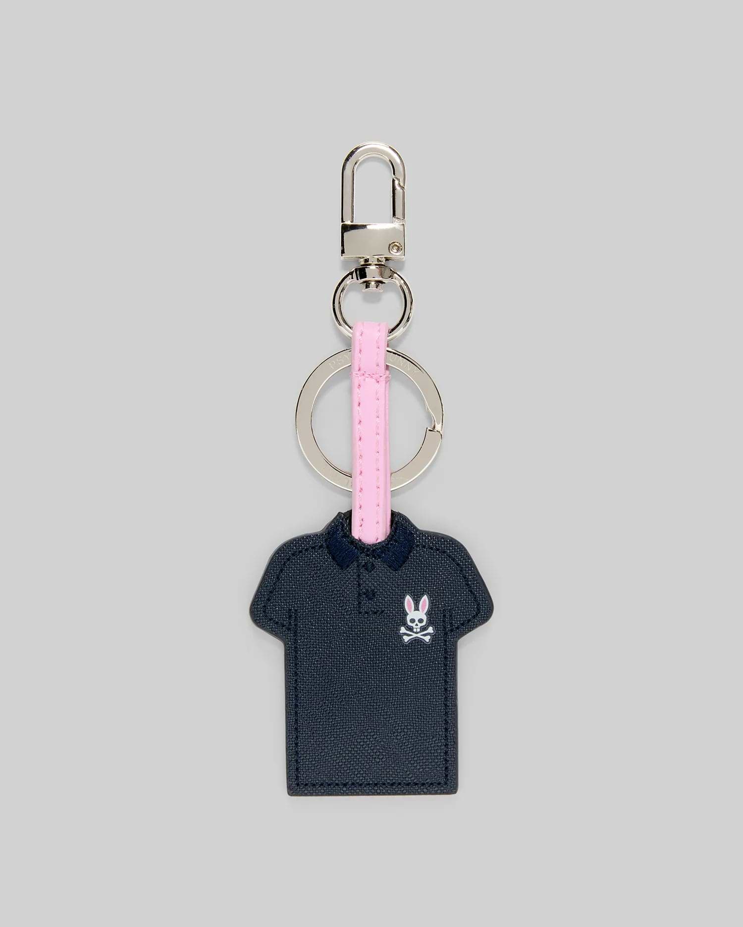 Iconic Polo Keychain featuring a navy blue textured faux leather polo shape with a small pink and white Psycho Bunny skull logo on the left chest, attached to a pink strap and silver metal hardware.