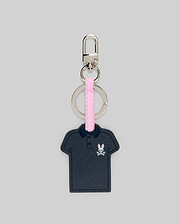 Iconic Polo Keychain featuring a navy blue textured faux leather polo shape with a small pink and white Psycho Bunny skull logo on the left chest, attached to a pink strap and silver metal hardware.