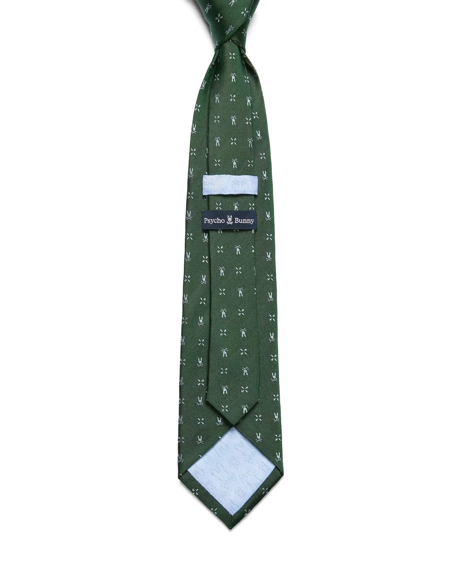 Mens Bunny Neat Woven Tie, a dark green woven tie featuring an all-over white Psycho Bunny skull and crossbones pattern, with a light blue keeper loop and patterned lining.