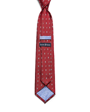 Mens Bunny Neat Woven Tie in red, featuring a repeated silver bunny skull logo pattern, a woven texture, and a light blue lining with a subtle bunny skull print. A black Psycho Bunny label is visible.