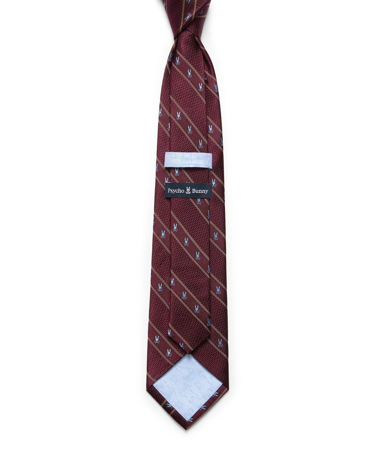 Mens Bunny Stripe Woven Tie in burgundy with diagonal gold stripes and a repeating light blue Psycho Bunny skull pattern. Woven texture, with a Psycho Bunny brand tag on the back.
