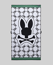 Mens All Over Bunny Towel in white terry cloth, featuring a large central black Psycho Bunny skull logo, an all-over repeating smaller black bunny skull pattern, and green and black striped borders.