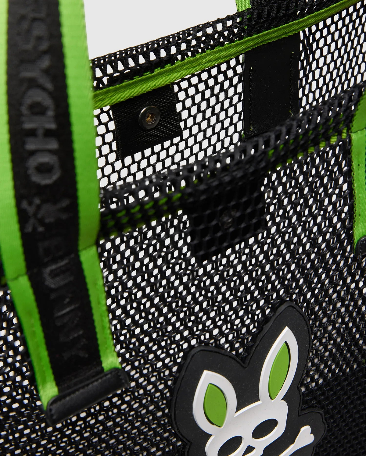 Black Mesh Tote Bag featuring a large rubberized white and neon green Psycho Bunny skull logo, neon green interior trim, and a black strap with a green stripe and Psycho Bunny text.