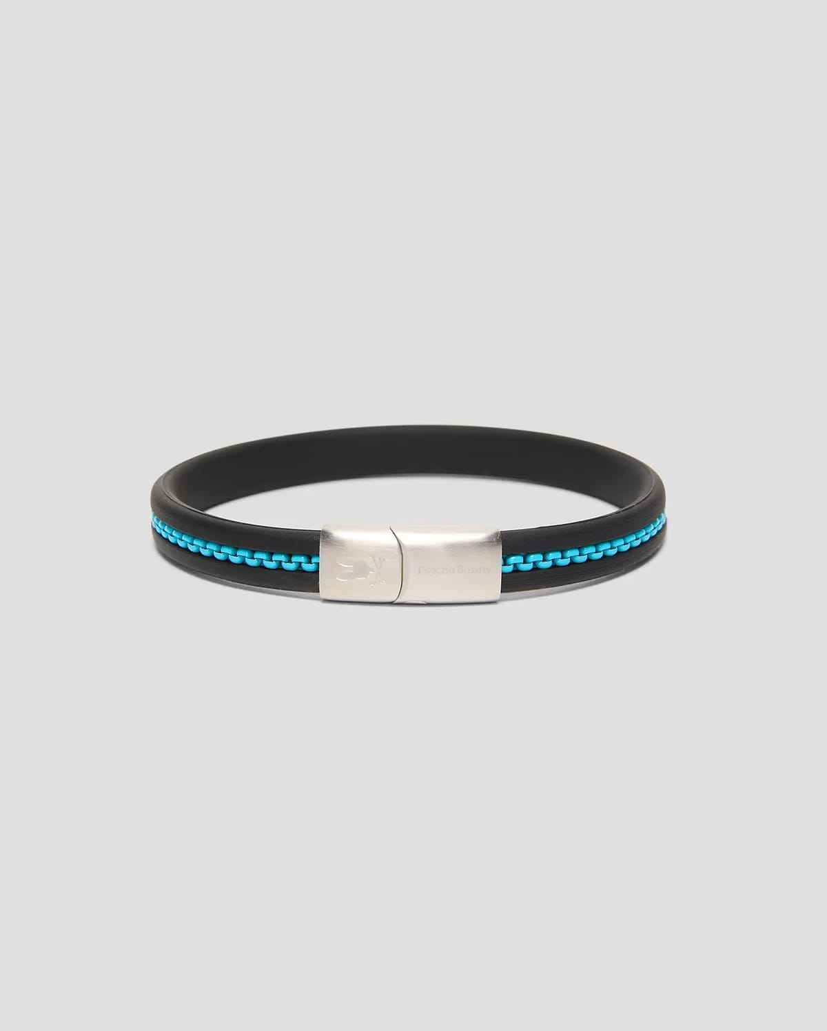 Mens Link Rubber Bracelet, a sleek black rubber band with a vibrant turquoise chain-link inlay and a polished silver clasp featuring engraved Psycho Bunny branding and skull logo.