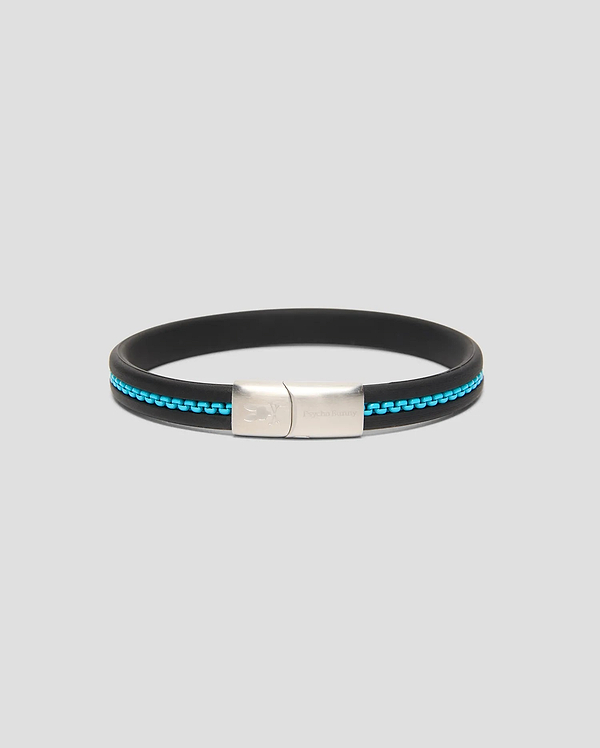 Mens Link Rubber Bracelet, a sleek black rubber band with a vibrant turquoise chain-link inlay and a polished silver clasp featuring engraved Psycho Bunny branding and skull logo.