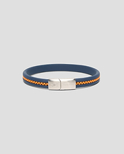 Mens Link Rubber Bracelet in navy blue rubber with an embedded orange chain detail, featuring a silver-toned metal clasp engraved with the Psycho Bunny skull logo and text.