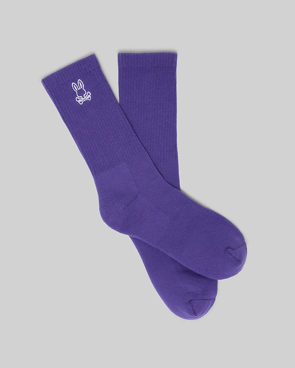 MENS NEW CLASSIC SPORT SOCK, a vibrant purple crew sock featuring a prominent white embroidered Psycho Bunny skull logo on the ribbed cuff, embodying refined streetwear style.