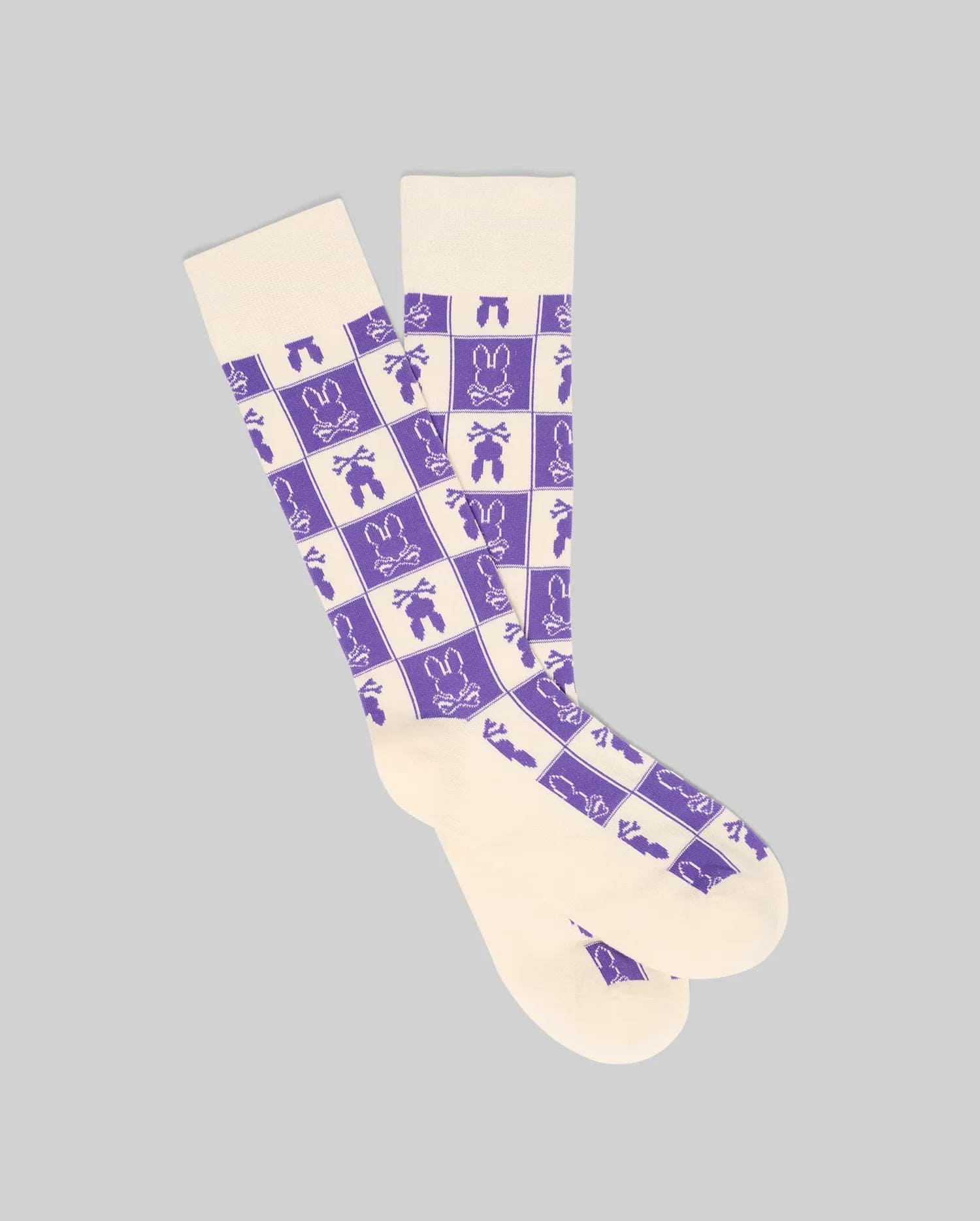 Mens All Over Square Bunny Dress Sock in cream with a purple checkerboard pattern featuring alternating Psycho Bunny skull logos, carrots, and bunny silhouettes.
