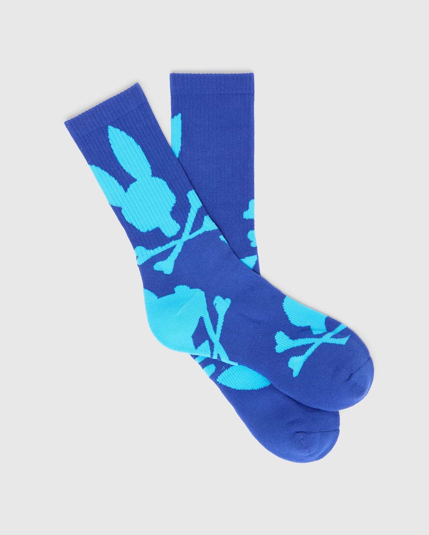 Mens Big Bunny Sport Sock, royal blue knit with a vibrant cyan all-over Psycho Bunny skull and crossbones logo pattern, featuring a ribbed cuff for a secure fit.