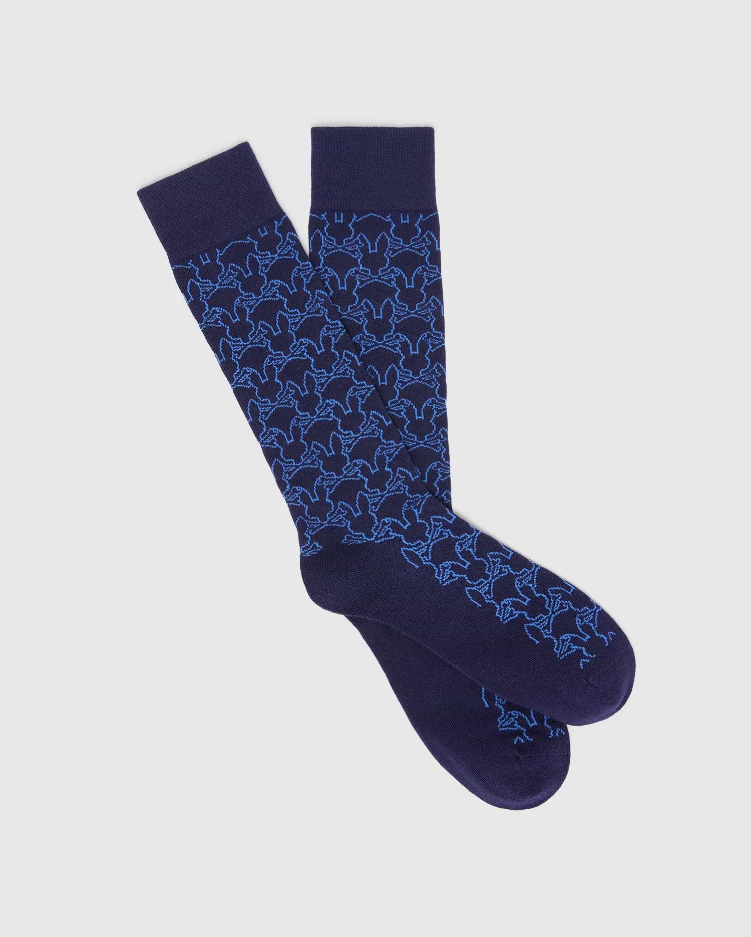 Mens Outline Bunny Dress Sock in deep navy, showcasing a vibrant light blue all-over pattern of the iconic Psycho Bunny skull outline on a smooth, premium knit.