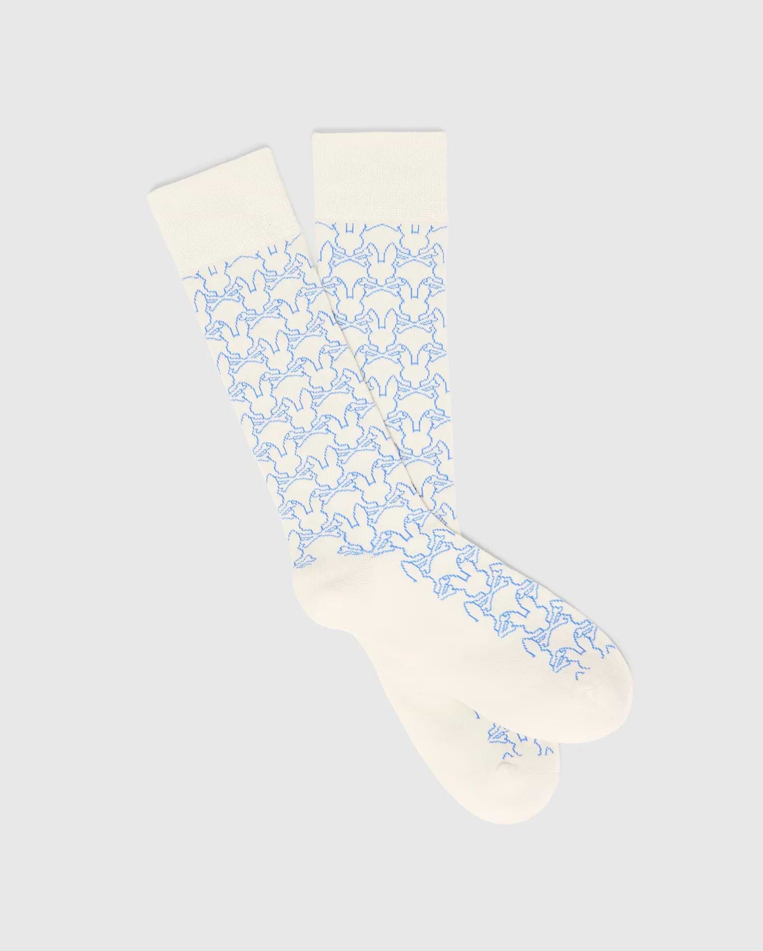 Mens Outline Bunny Dress Sock in cream with a vibrant light blue all-over embroidered Psycho Bunny skull logo pattern, crafted from a smooth knit fabric. (1)