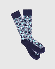 Navy knit Mens Frank Dress Socks with an all-over diamond pattern featuring white Psycho Bunny skull and crossbones logos on an aqua background, finished with navy cuff, heel, and toe.