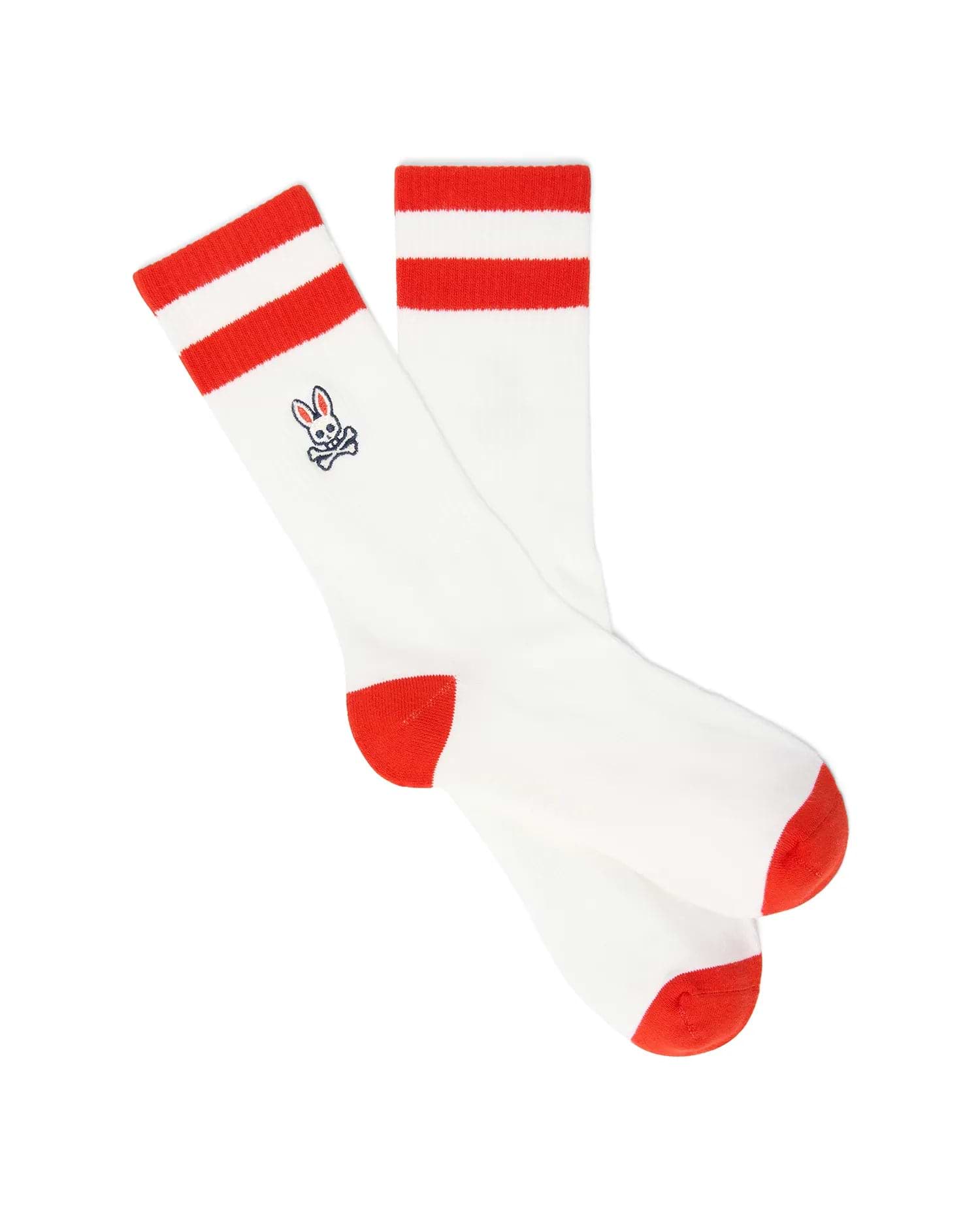 Mens Pal Sport Sock, white knit socks featuring two bold red stripes on the cuff, a vibrant red heel and toe, and a small embroidered blue and white Psycho Bunny skull logo on the ankle.
