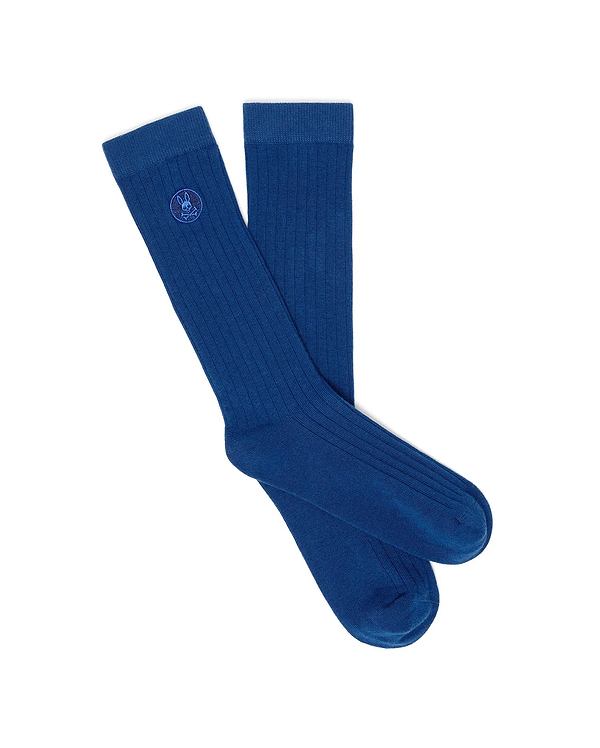 Mens Nathaniel Dress Sock in vibrant royal blue, crafted from a classic ribbed knit fabric, prominently featuring a small, tonal embroidered Psycho Bunny skull and crossbones logo on the outer cuff.