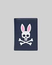 Navy Passport Holder with a large, centered white and pink Psycho Bunny skull and crossbones logo on a smooth faux leather texture.