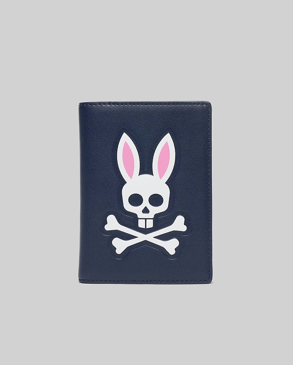Navy Passport Holder with a large, centered white and pink Psycho Bunny skull and crossbones logo on a smooth faux leather texture.