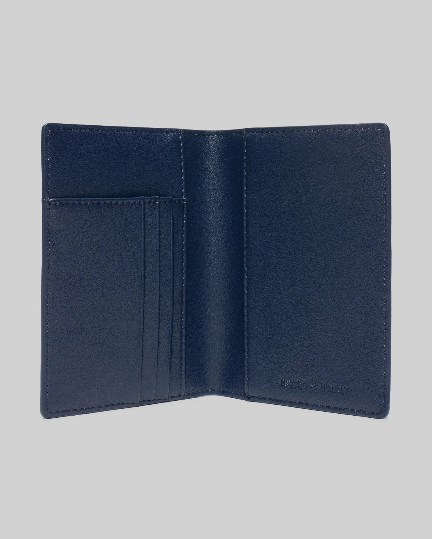 Navy Blue Grained Faux Leather Passport Holder, featuring a refined, open design with multiple interior card slots and a subtly embossed Psycho Bunny logo for premium style.